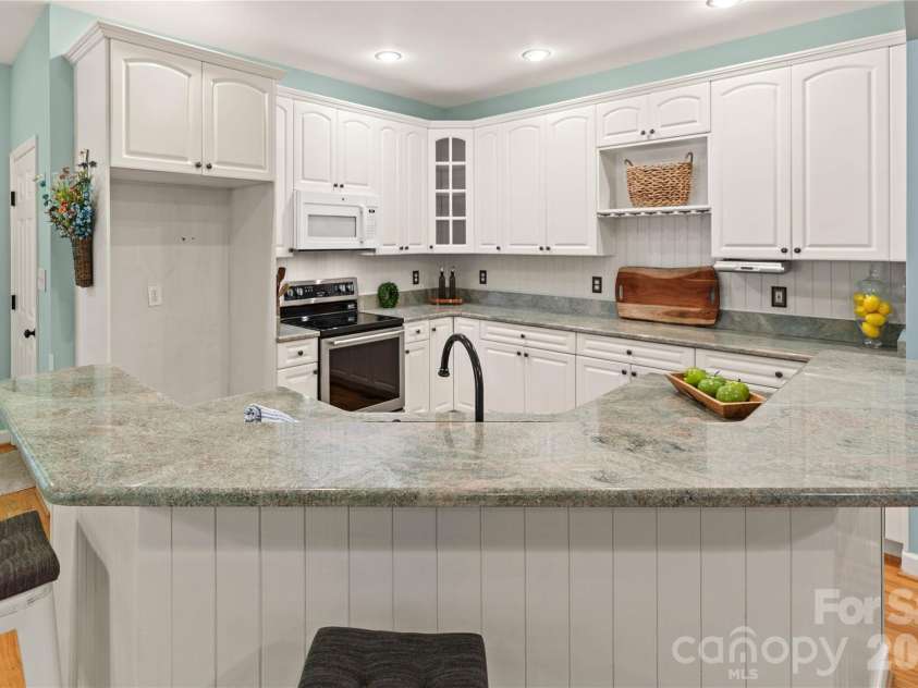 2017 Cameron Heights Circle, Denver, NC 28037.  MLS# CAR4410904, YatesRealty ID 47075. Efficient kitchen with loads of counterspace.  Shiplap detail applied to the kitchen island/breakfast bar as well as on the backsplash.