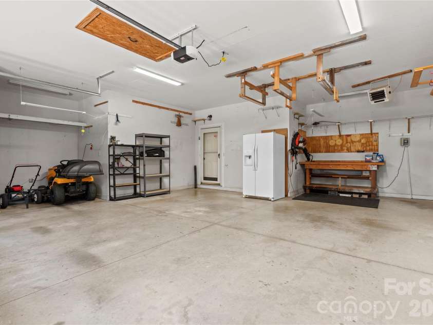 2017 Cameron Heights Circle, Denver, NC 28037.  MLS# CAR4410904, YatesRealty ID 47075. Hobbyist will love the oversized garage.  Refrigerator and workbench remain.  Ceiling mounted heater! There is a garage access door on the right wall (not shown in pic) to the side yard.