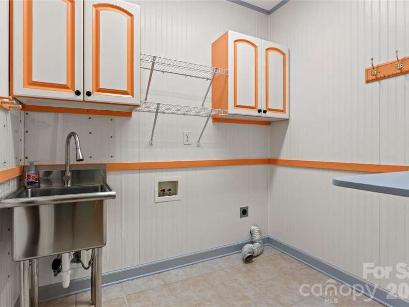 2017 Cameron Heights Circle, Denver, NC 28037.  MLS# CAR4410904, YatesRealty ID 47075. Laundry room, finished with beadboard boasts cabinetry and shelving for organization, stainless steel laundry sink and convenient folding table! Located directly outside of the primary suite.