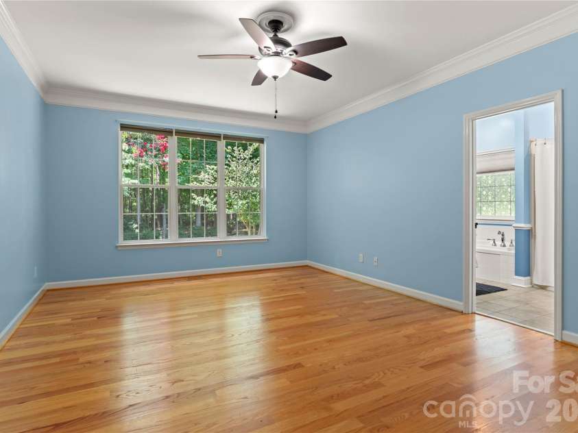 2017 Cameron Heights Circle, Denver, NC 28037.  MLS# CAR4410904, YatesRealty ID 47075. Spacious and private primary suite overlooking the landscaped grounds.  Site finished hardwoods and crown moulding!