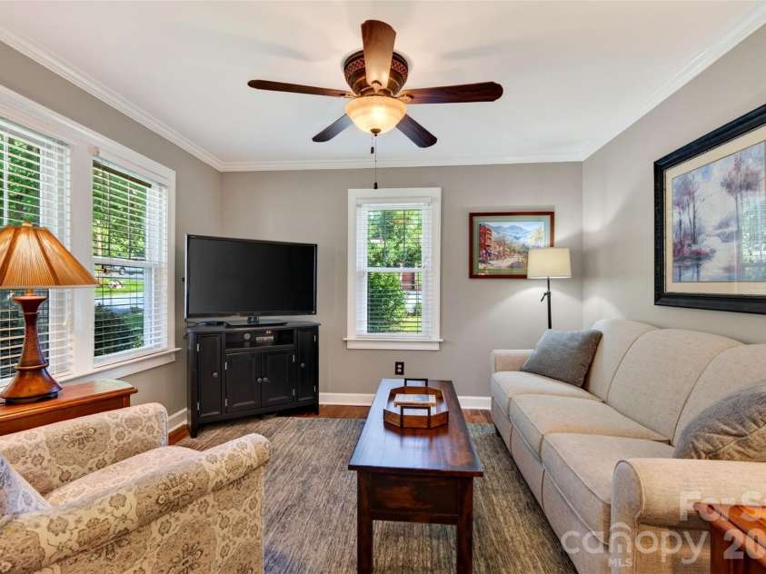 206 Kerlee Heights Road, Black Mountain, NC 28711.  MLS# CAR4414870, YatesRealty ID 47078. Multiple windows brighten the living room and frame leafy views, giving this comfortable gathering space an open, cheerful feel.