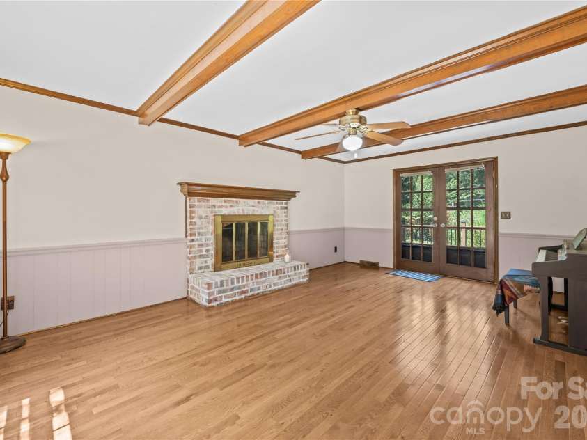 8800 Glencroft Road, Charlotte, NC 28227.  MLS# CAR4416112, YatesRealty ID 47087. Den with wood burning fire place