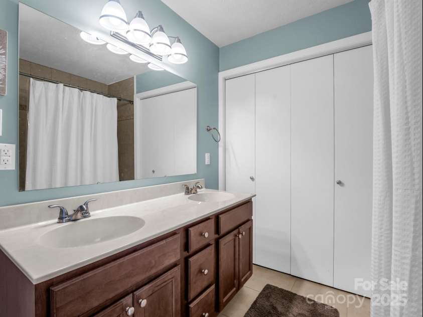 19 Robert E Lee Drive, Flat Rock, NC 28731.  MLS# CAR4235643, YatesRealty ID 4712. Full bath vanity and closet with hookups for laundry