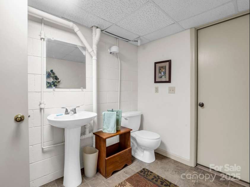 19 Robert E Lee Drive, Flat Rock, NC 28731.  MLS# CAR4235643, YatesRealty ID 4712. Lower level half bath