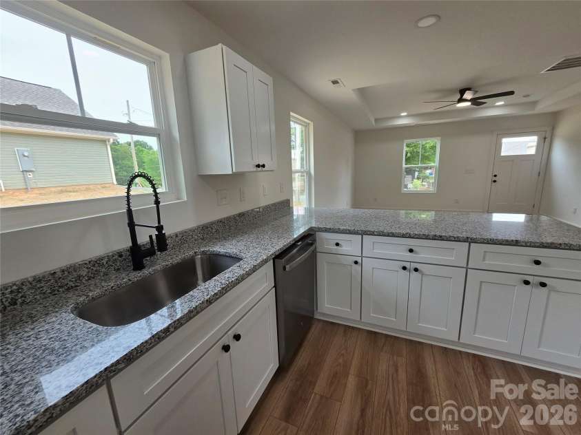 911 Hill Street, Albemarle, NC 28001.  MLS# CAR4407669, YatesRealty ID 47127. Modern pull down faucet, stainless steel undermount sink, island storage