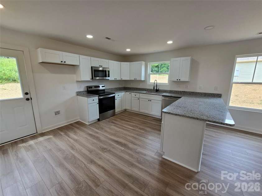 911 Hill Street, Albemarle, NC 28001.  MLS# CAR4407669, YatesRealty ID 47127. Open Kitchen with large eat in island, abundant storage