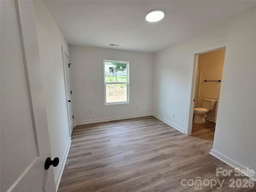 911 Hill Street, Albemarle, NC 28001.  MLS# CAR4407669, YatesRealty ID 47127. Primary bedroom with full ensuite bathroom