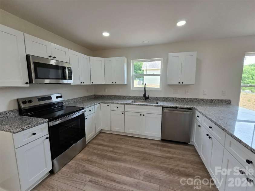 911 Hill Street, Albemarle, NC 28001.  MLS# CAR4407669, YatesRealty ID 47127. Timeless granite counters, shaker soft close cabinetry