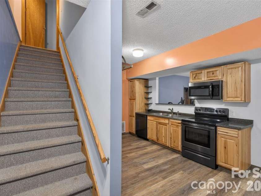 00 Misery Ridge Trail, Mill Spring, NC 28756.  MLS# CAR4385906, YatesRealty ID 47162. Stairs from basement apartment to upper level.