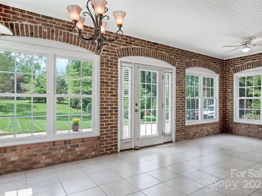 218 Fairway Drive, Shelby, NC 28150.  MLS# CAR4129420, YatesRealty ID 4717. Lower-level sunroom room is a dream entertaining space.  Direct access to the back patio and the second kitchen.