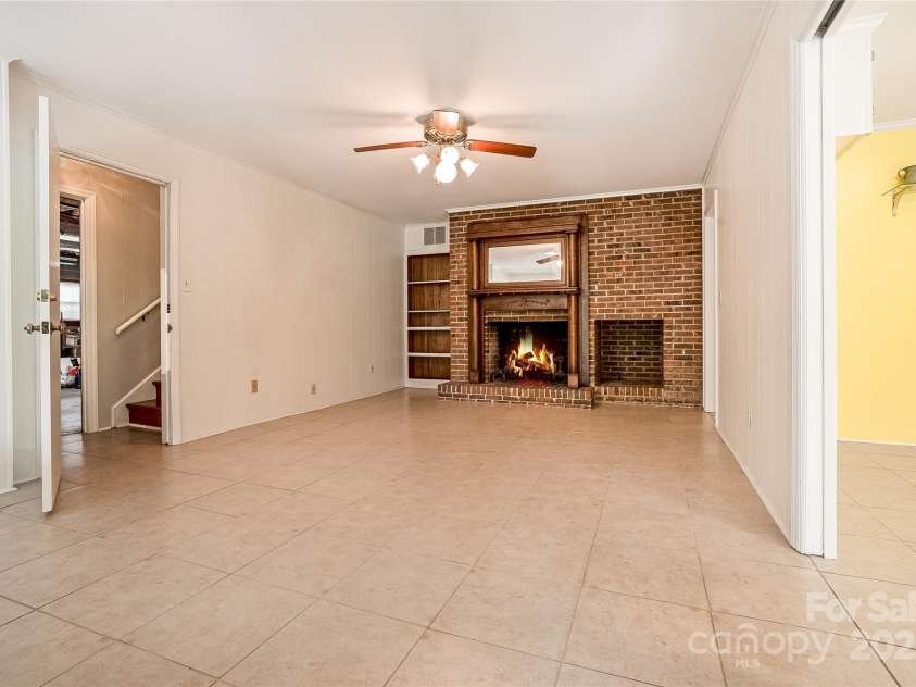 218 Fairway Drive, Shelby, NC 28150.  MLS# CAR4129420, YatesRealty ID 4717. The lower level has access to the two-car garage, workshop area, massive storage and stairs to upper floor. There are also fixed stairs to the attic space that could add another bonus area if needed.