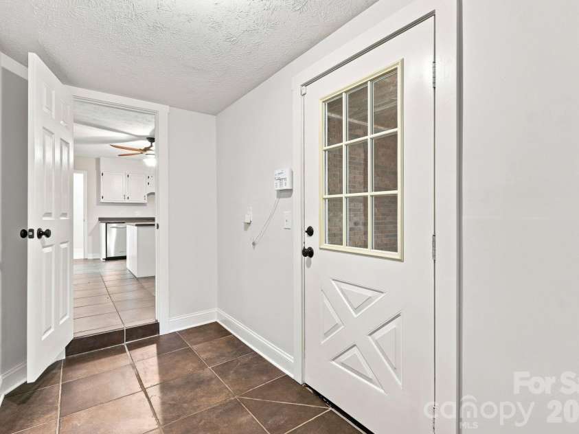 151 Ridgewood Acres Drive, Hendersonville, NC 28792.  MLS# CAR4418419, YatesRealty ID 47183. Mudroom with separate carport access