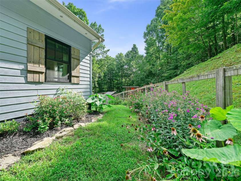 1523 Roaring Fork Road, Burnsville, NC 28714.  MLS# CAR4408382, YatesRealty ID 47187. Side Yard