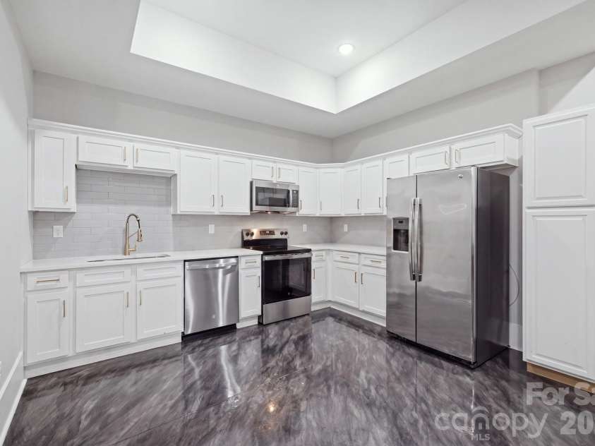 6021 Monticello Drive, Concord, NC 28027.  MLS# CAR4418703, YatesRealty ID 47198. Full lower-level kitchen with ample cabinetry