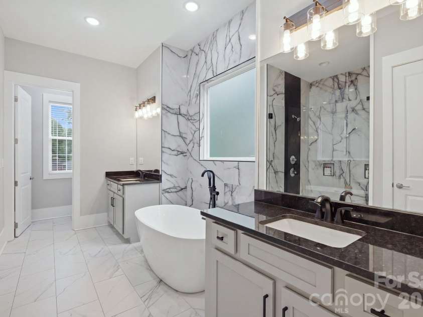 6021 Monticello Drive, Concord, NC 28027.  MLS# CAR4418703, YatesRealty ID 47198. Primary bath with dual vanity and custom tiled shower