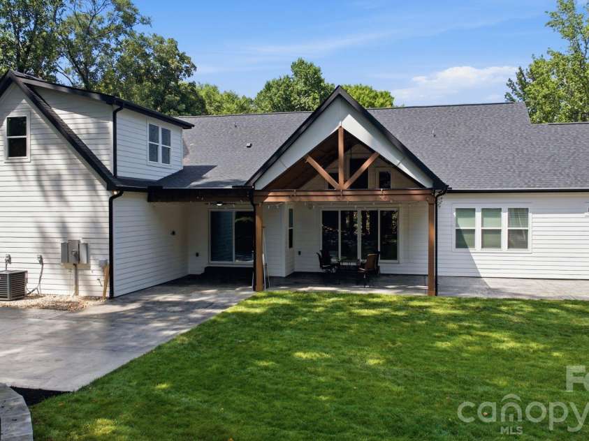 6021 Monticello Drive, Concord, NC 28027.  MLS# CAR4418703, YatesRealty ID 47198. Rear elevation showcasing the home’s architecture and outdoor spaces