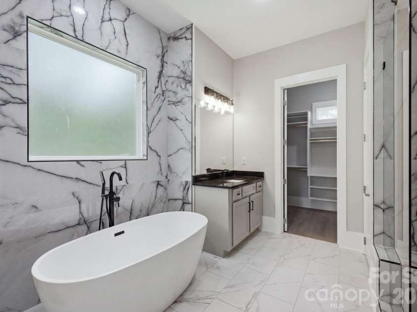6021 Monticello Drive, Concord, NC 28027.  MLS# CAR4418703, YatesRealty ID 47198. Spa-inspired primary bath with freestanding soaking tub
