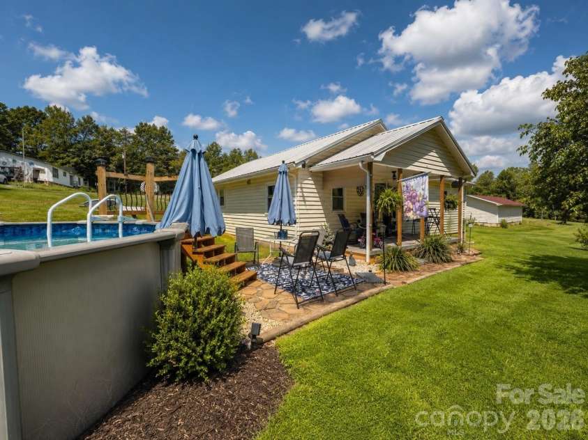 1843 US Highway 70 Highway, Connelly Springs, NC 28612.  MLS# CAR4418867, YatesRealty ID 47200. Pool and home side view