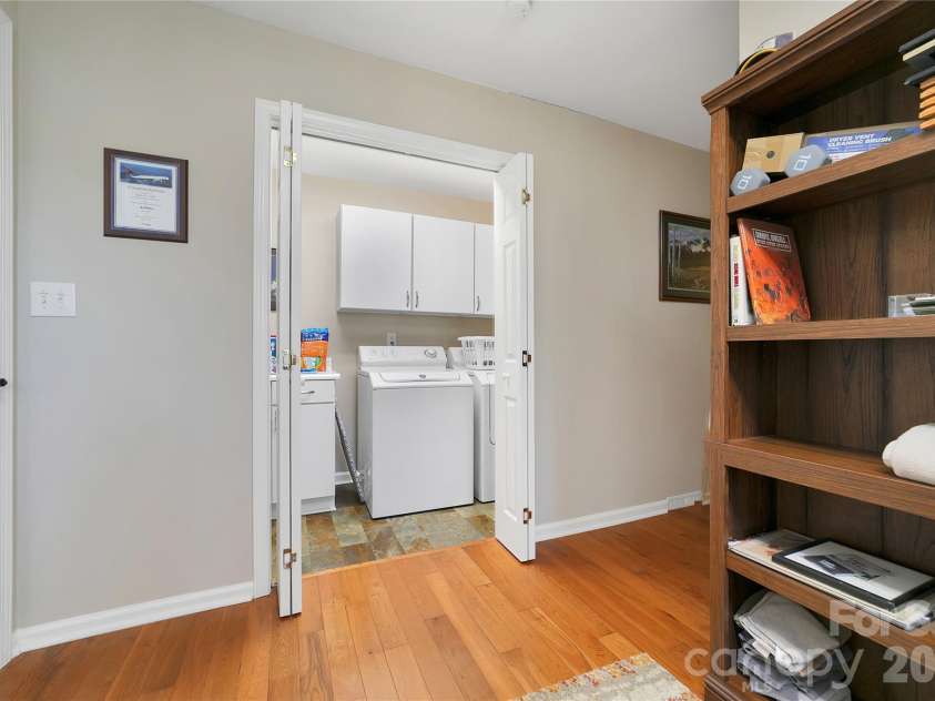 59 Agaliha Lane, Brevard, NC 28712.  MLS# CAR4338161, YatesRealty ID 4724. Across the hallway from the office looks like a regular closet, but is actually the laundry space.