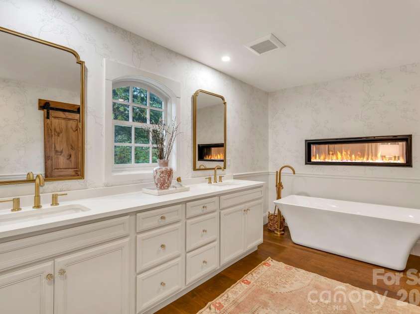 368 Green Hill Woods, Blowing Rock, NC 28605.  MLS# CAR4411772, YatesRealty ID 47263. Primary suite bath with 2 sided fireplace and large soaking tub.