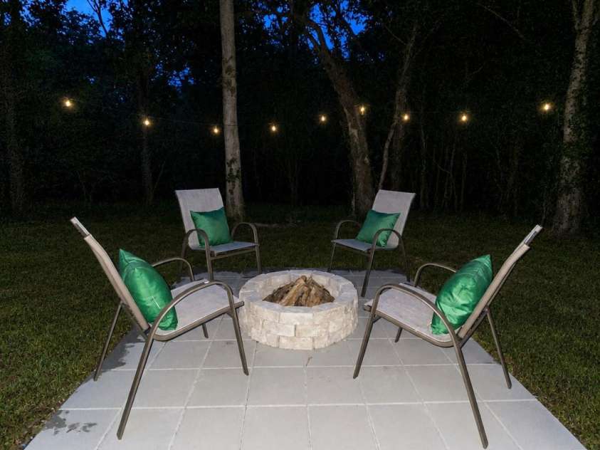 310 Elm Street, Lancaster, SC 29720.  MLS# CAR4419096, YatesRealty ID 47298. Back yard fire pit - evening photo.