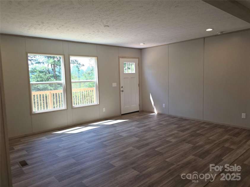 12 McGee Hill Road, Fairview, NC 28730.  MLS# CAR4234787, YatesRealty ID 4733. Large open living space.