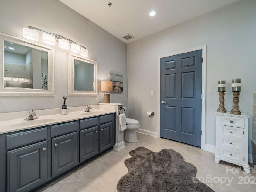 637 Williamson Road, Mooresville, NC 28117.  MLS# CAR4247530, YatesRealty ID 4736. Primary bath with 2 sinks, jetted tub, shower and walk in custom closet.