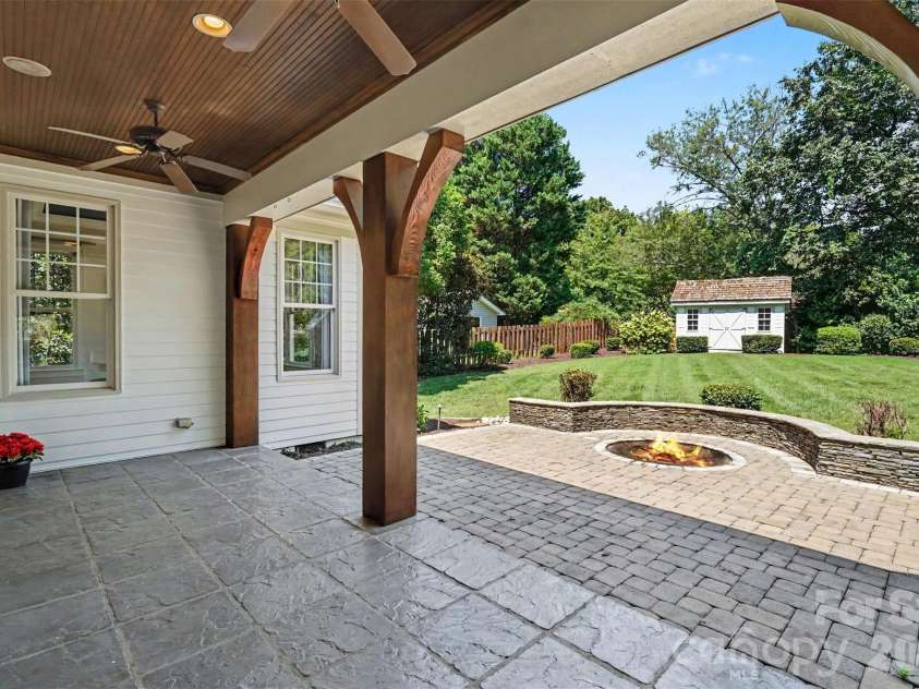 21253 Sandy Cove Road, Cornelius, NC 28031.  MLS# CAR4417192, YatesRealty ID 47365. Covered back porch with paver patio and fire pit