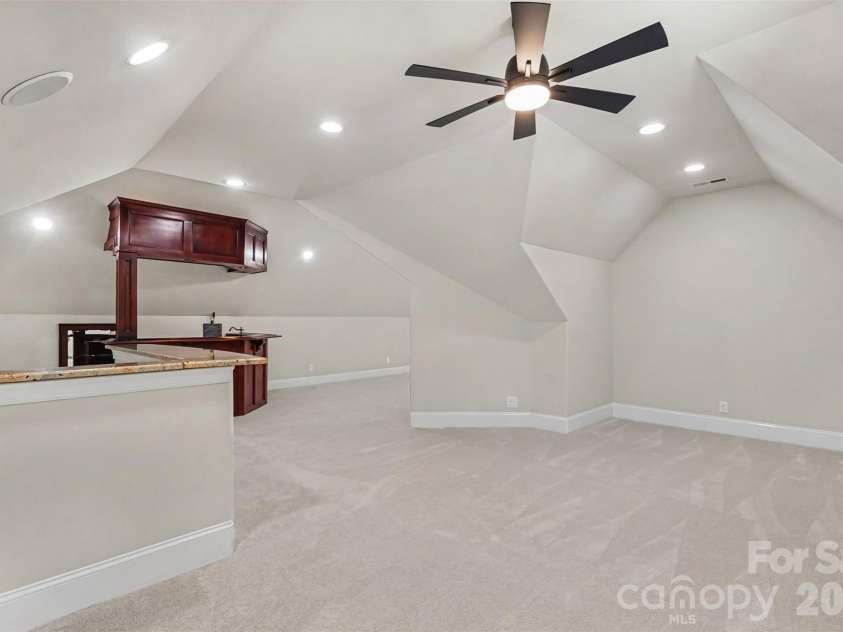 21253 Sandy Cove Road, Cornelius, NC 28031.  MLS# CAR4417192, YatesRealty ID 47365. Large bonus room with built in bar