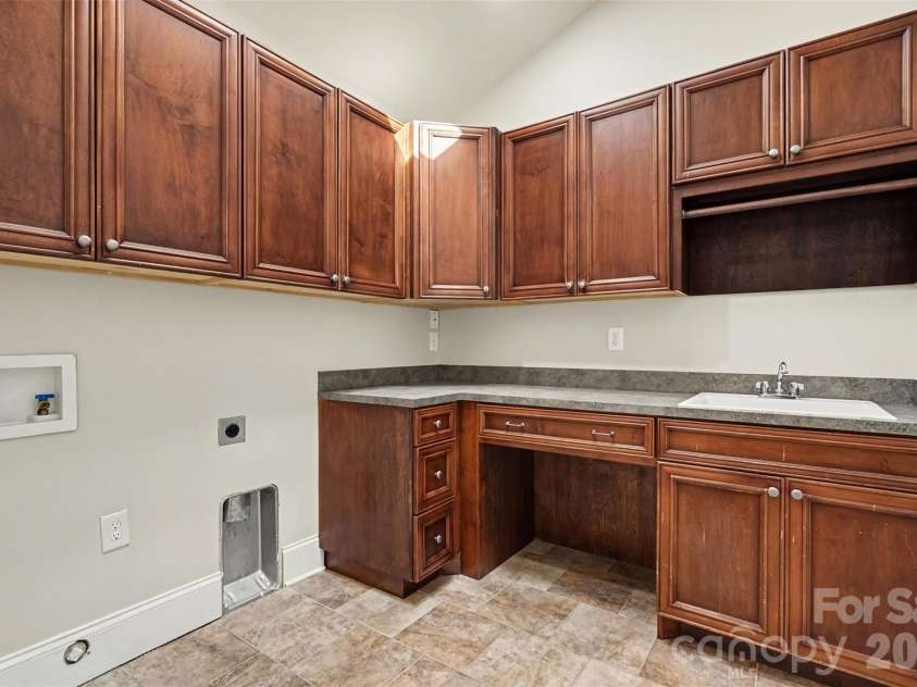 21253 Sandy Cove Road, Cornelius, NC 28031.  MLS# CAR4417192, YatesRealty ID 47365. Laundry room with extra storage and folding area
