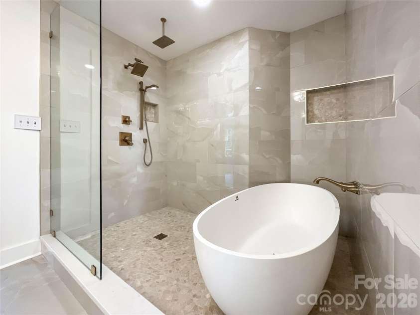 3011 Parkstone Drive, Charlotte, NC 28210.  MLS# CAR4418813, YatesRealty ID 47373. Spa style master bath with stone soaking tub.   Shower system includes rain head, main head, and hand held.