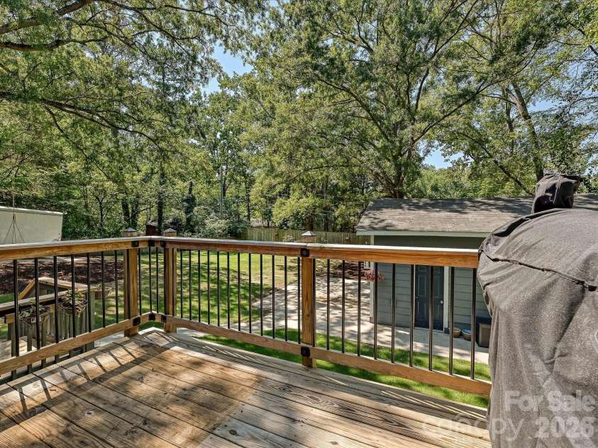 1901 Balfour Lane, Charlotte, NC 28216.  MLS# CAR4416656, YatesRealty ID 47405. Spacious back deck overlooks a peaceful, tree-lined backyard with easy access to the detached outbuilding.