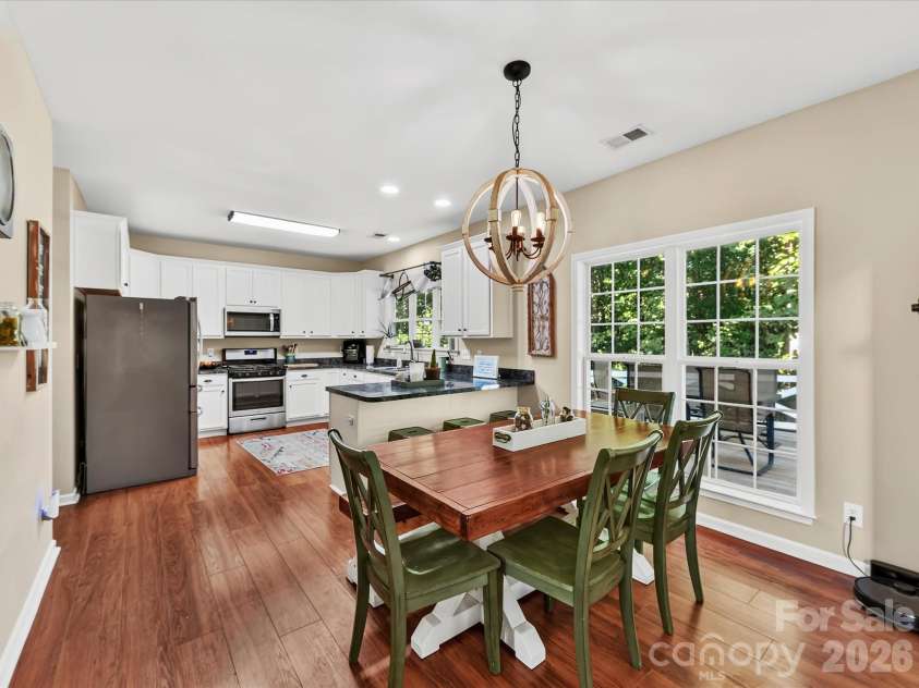 150 Cavendish Drive, Mooresville, NC 28115.  MLS# CAR4416863, YatesRealty ID 47420. Bright dining area featuring oversized windows with peaceful backyard views, and an open connection to the kitchen and Great Room.