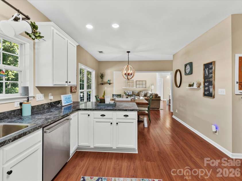 150 Cavendish Drive, Mooresville, NC 28115.  MLS# CAR4416863, YatesRealty ID 47420. Bright, functional kitchen featuring crisp white cabinetry, stainless steel appliances, abundant counter space, a breakfast bar with seating, and an open connection to the dining and Great Room.