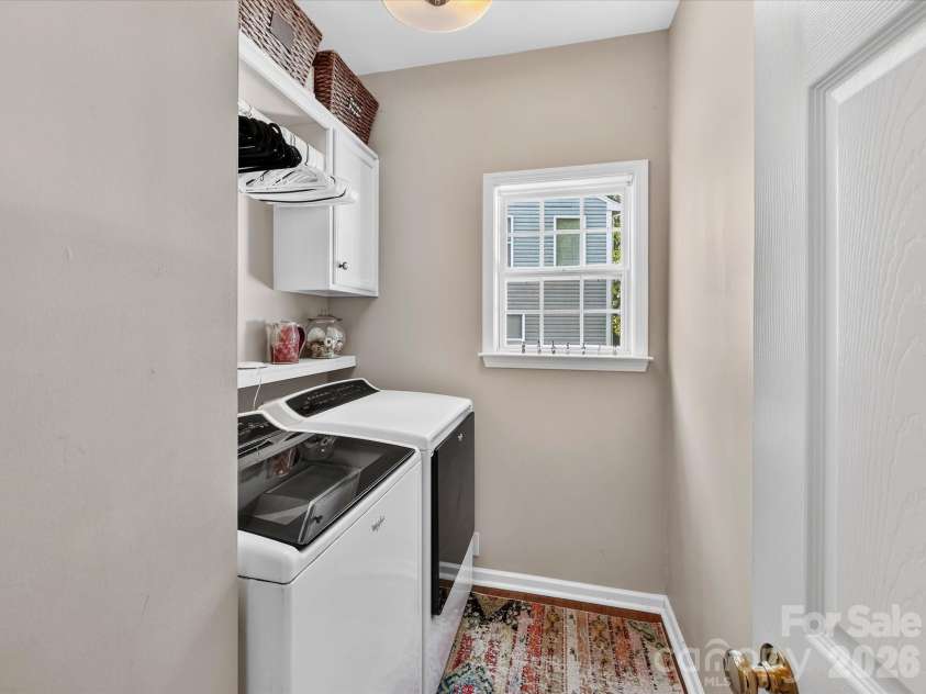 150 Cavendish Drive, Mooresville, NC 28115.  MLS# CAR4416863, YatesRealty ID 47420. Bright, functional laundry room featuring built-in cabinetry and shelving for added storage, plus a window that brings in natural light.