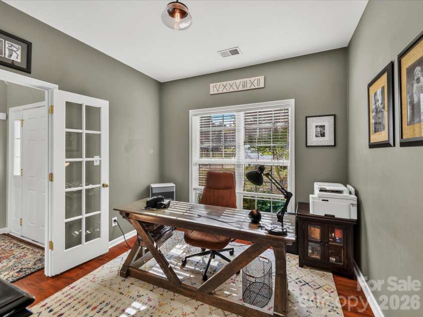 150 Cavendish Drive, Mooresville, NC 28115.  MLS# CAR4416863, YatesRealty ID 47420. Bright home office featuring beautiful flooring, a large window with abundant natural light, and French doors for added privacy.