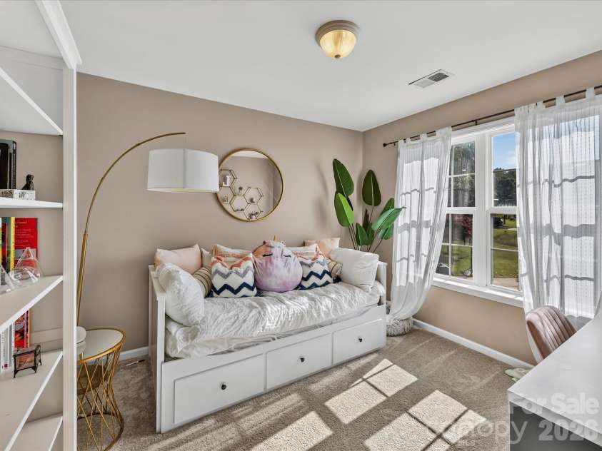 150 Cavendish Drive, Mooresville, NC 28115.  MLS# CAR4416863, YatesRealty ID 47420. Bright secondary bedroom featuring soft carpeting, generous natural light, and ample space for a bed, desk, or reading area.