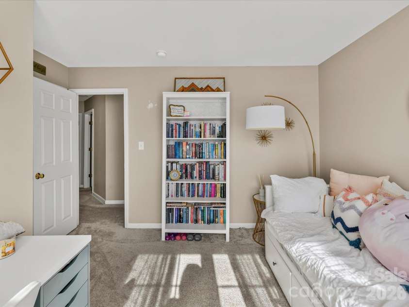 150 Cavendish Drive, Mooresville, NC 28115.  MLS# CAR4416863, YatesRealty ID 47420. Bright secondary bedroom featuring soft carpeting, generous natural light, and ample space for a bed, desk, or reading area.