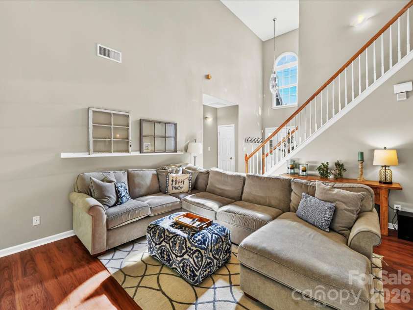 150 Cavendish Drive, Mooresville, NC 28115.  MLS# CAR4416863, YatesRealty ID 47420. Spacious Great Room featuring soaring ceilings, a cozy fireplace, abundant natural light, and an open flow to the kitchen and dining area.