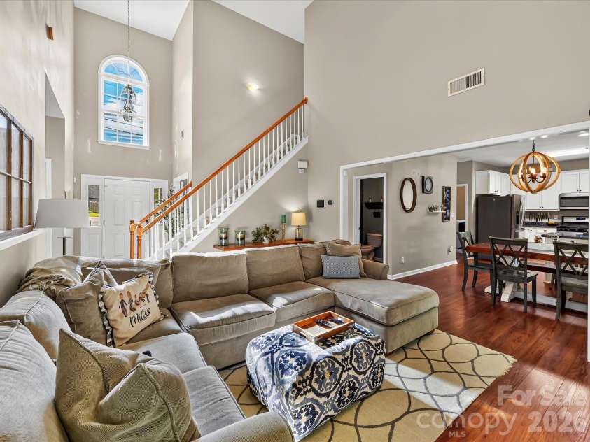 150 Cavendish Drive, Mooresville, NC 28115.  MLS# CAR4416863, YatesRealty ID 47420. Spacious Great Room featuring soaring ceilings, a cozy fireplace, abundant natural light, and an open flow to the kitchen and dining area.