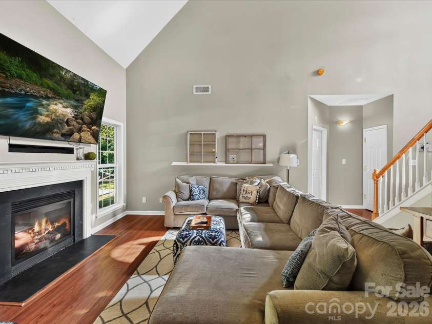 150 Cavendish Drive, Mooresville, NC 28115.  MLS# CAR4416863, YatesRealty ID 47420. Spacious Great Room featuring soaring ceilings, a cozy fireplace, abundant natural light, and an open flow to the kitchen and dining area.