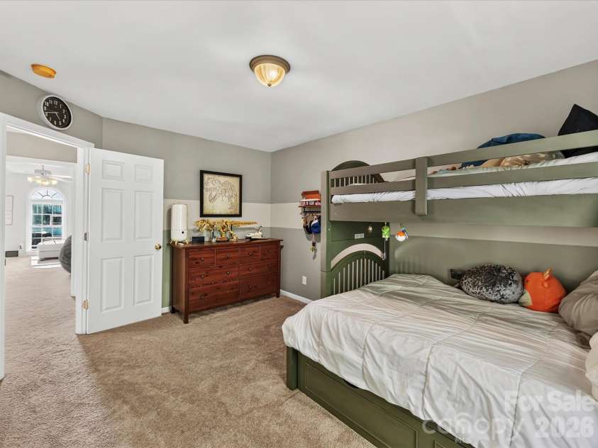 150 Cavendish Drive, Mooresville, NC 28115.  MLS# CAR4416863, YatesRealty ID 47420. Spacious secondary bedroom featuring soft carpeting, a large window with natural light, and plenty of room for flexible furniture arrangements.