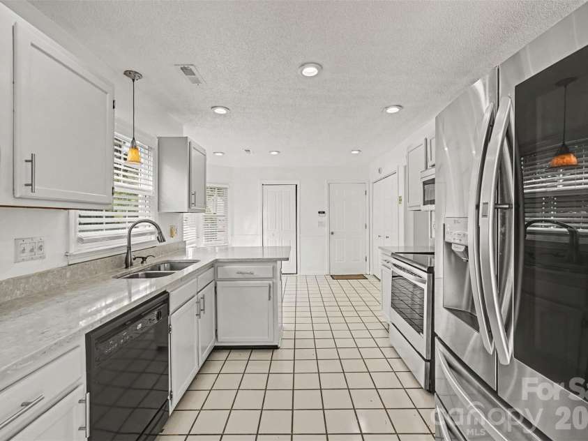 10117 Crayton Drive, Charlotte, NC 28269.  MLS# CAR4415978, YatesRealty ID 47431. Kitchen with stainless steel appliances.