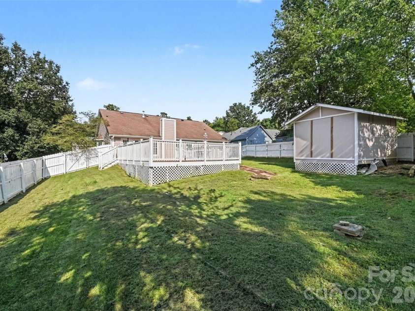 10117 Crayton Drive, Charlotte, NC 28269.  MLS# CAR4415978, YatesRealty ID 47431. Large fenced backyard with storage shed.