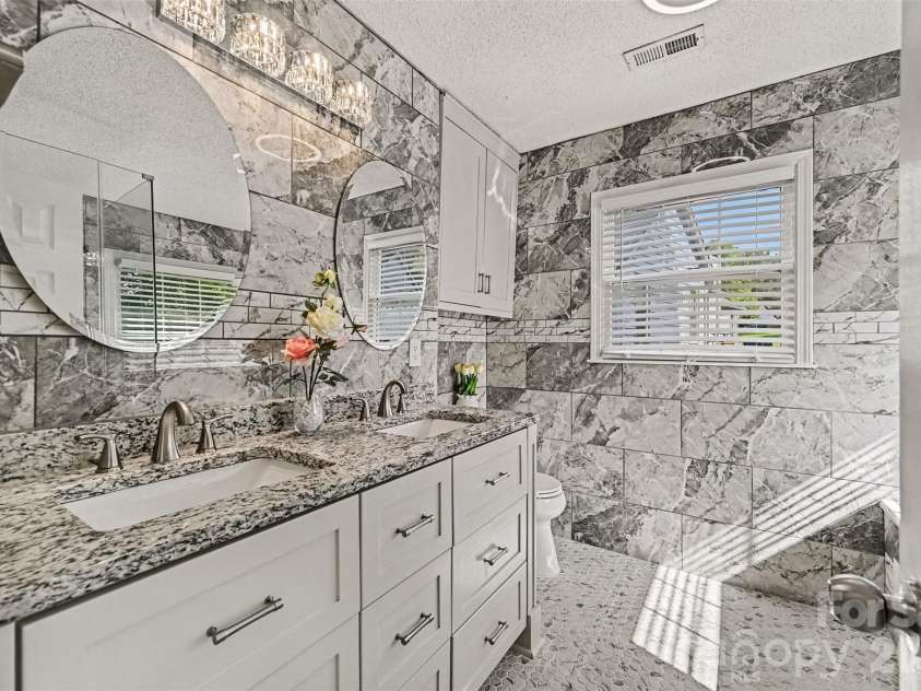 10117 Crayton Drive, Charlotte, NC 28269.  MLS# CAR4415978, YatesRealty ID 47431. Primary bathroom with double vanity.