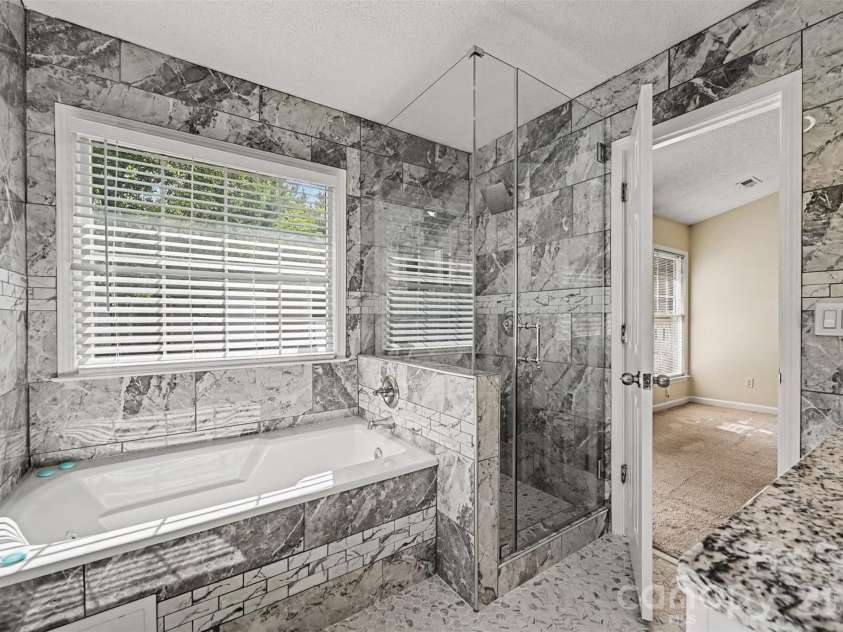 10117 Crayton Drive, Charlotte, NC 28269.  MLS# CAR4415978, YatesRealty ID 47431. Primary bathroom with soaking tub and separate shower.