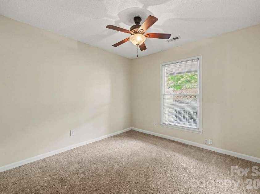 10117 Crayton Drive, Charlotte, NC 28269.  MLS# CAR4415978, YatesRealty ID 47431. Secondary bedroom with ceiling fan.