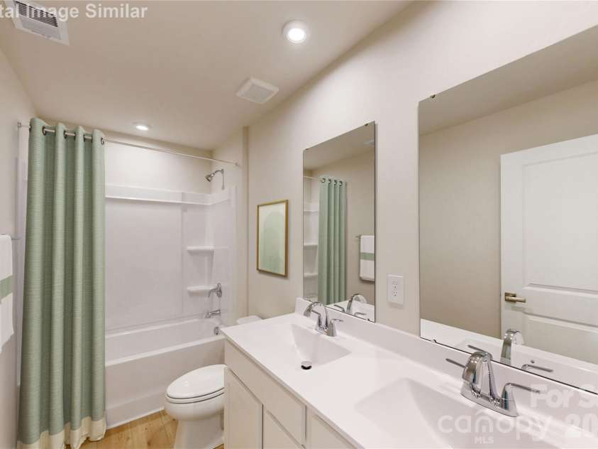 131 Auburn Hills Drive, Albemarle, NC 28001.  MLS# CAR4416520, YatesRealty ID 47445. This guest bath blends fun and function! The tub is perfect for splashy playtime or a relaxing soak, while dual vanities and mirrors make busy mornings a breeze. With plenty of cabinet storage, it’s stylish, spaciou