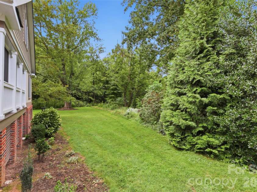 18 Creekside Way, Asheville, NC 28804.  MLS# CAR4411851, YatesRealty ID 47449. Lush side gardens