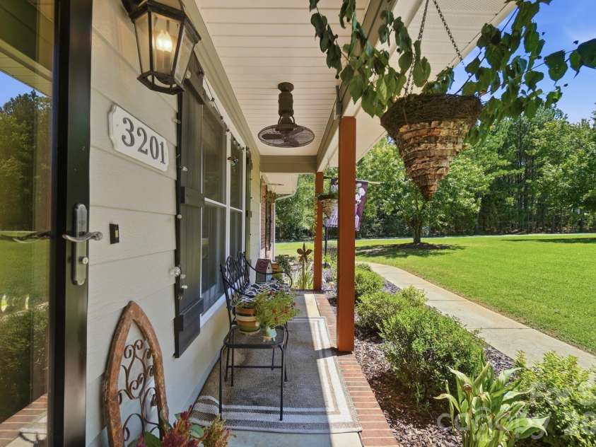 3201 Gilboa Road, Wingate, NC 28174.  MLS# CAR4415181, YatesRealty ID 47454. A fan on the front porch makes warm days enjoyable.